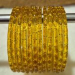 पिले कलर मे काँच की 12 चुडी